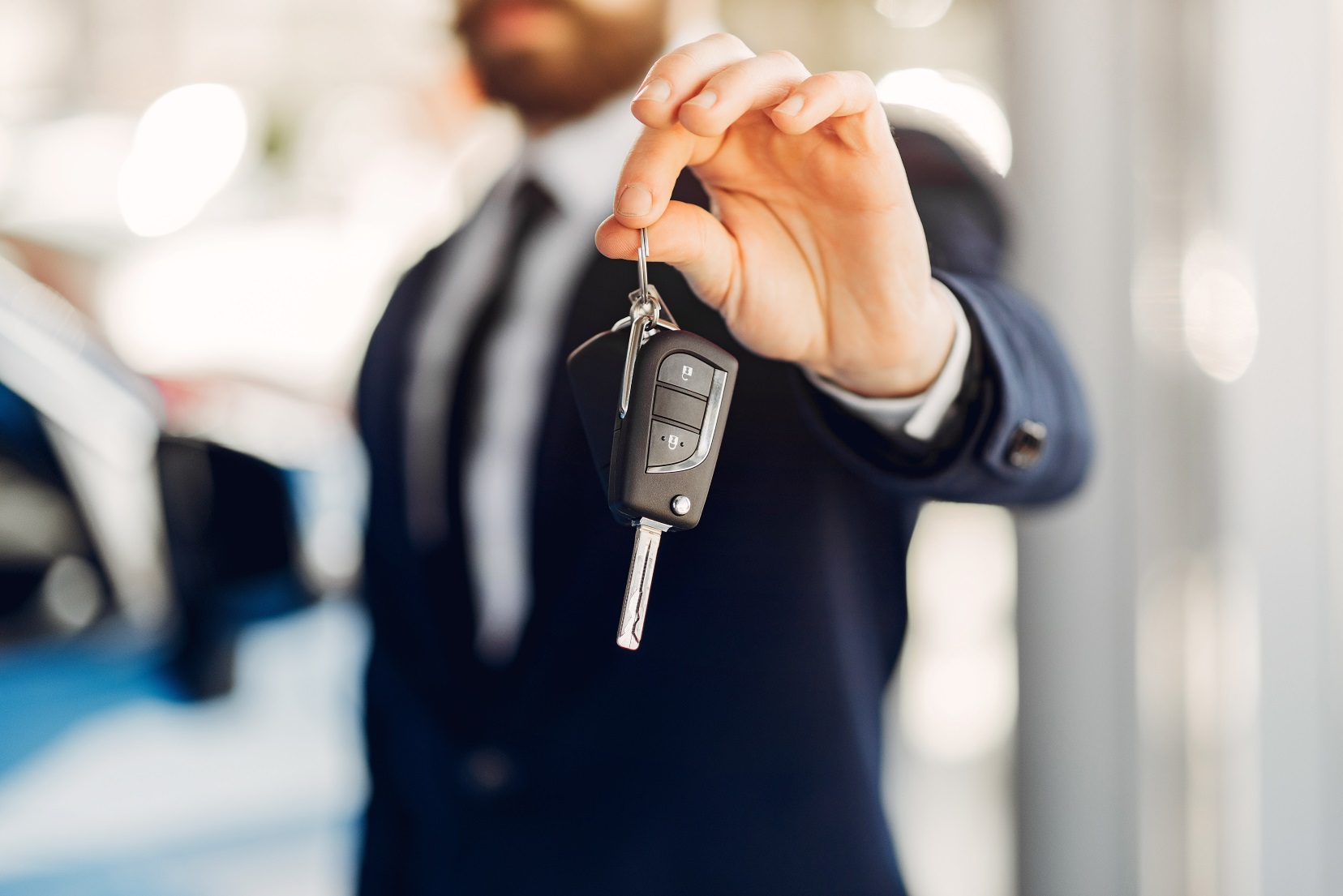 Man buying the car. Businessman in a car salon Man buying the car. Businessman in a car salon